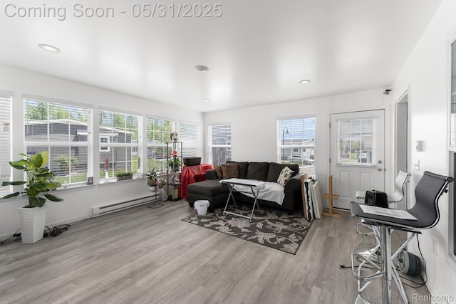 8551 Boyer Dr, Willis, MI 48191 - living area with a baseboard heating unit, light wood-style floors, plenty of natural light, and recessed lighting