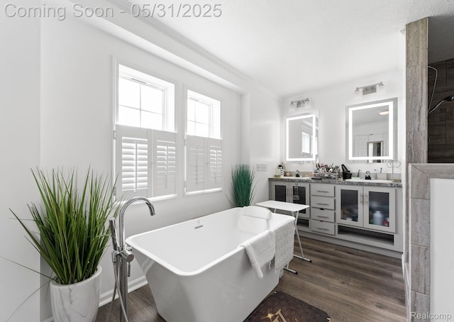 8551 Boyer Dr, Willis, MI 48191 - full bathroom with double vanity, a freestanding bath, wood finished floors, and wine cooler