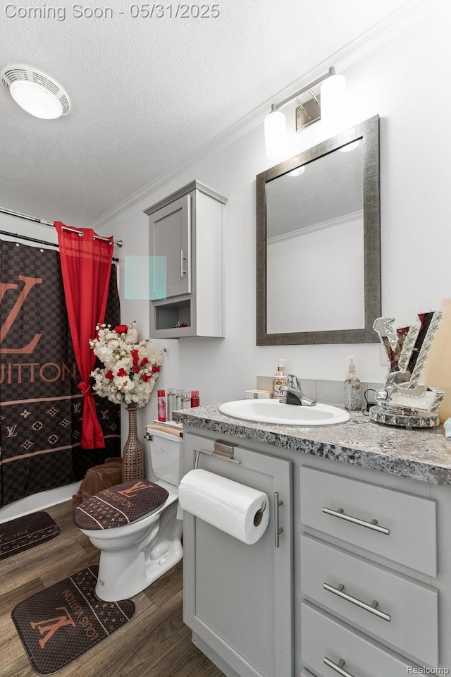 8551 Boyer Dr, Willis, MI 48191 - full bathroom with crown molding, vanity, wood finished floors, curtained shower, and toilet
