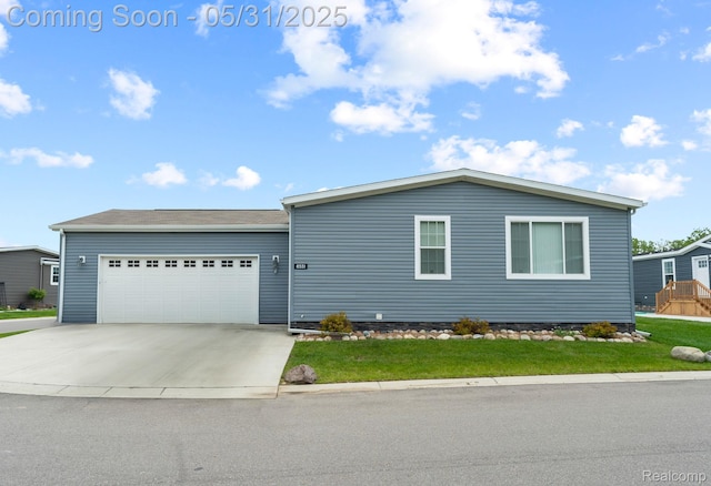 8551 Boyer Dr, Willis, MI 48191 - view of front of property featuring a garage, concrete driveway, and a front yard
