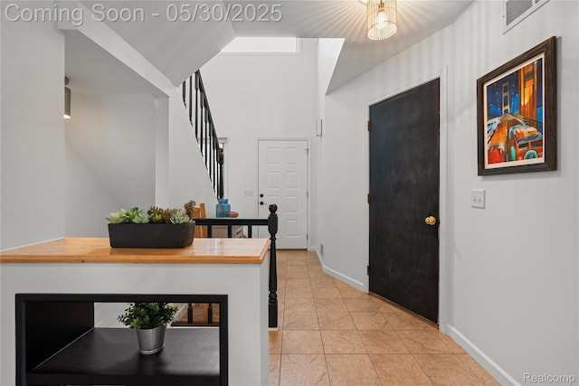 50820 Marsha Ln, New Baltimore, MI 48047 - corridor with light tile patterned flooring, stairs, and baseboards