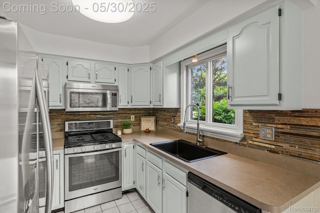 50820 Marsha Ln, New Baltimore, MI 48047 - kitchen with stainless steel appliances, a sink, tasteful backsplash, light tile patterned flooring, and light countertops