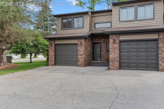 50820 Marsha Ln, New Baltimore, MI 48047 - view of front of house with brick siding, a garage, and asphalt driveway