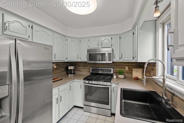 50820 Marsha Ln, New Baltimore, MI 48047 - kitchen with appliances with stainless steel finishes, a sink, light countertops, and light tile patterned floors