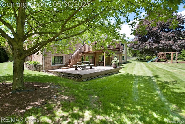 44500 Louvert Ct, Novi, MI 48375 - view of green lawn featuring a wooden deck, a playground, and stairs