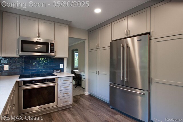 44500 Louvert Ct, Novi, MI 48375 - kitchen with appliances with stainless steel finishes, dark wood-style floors, light countertops, backsplash, and recessed lighting