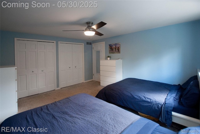 44500 Louvert Ct, Novi, MI 48375 - bedroom featuring carpet, two closets, and ceiling fan