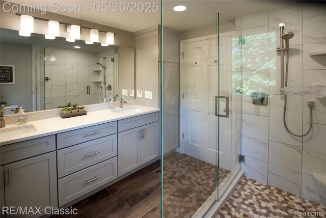 44500 Louvert Ct, Novi, MI 48375 - full bath with double vanity, a shower stall, recessed lighting, and wood finished floors