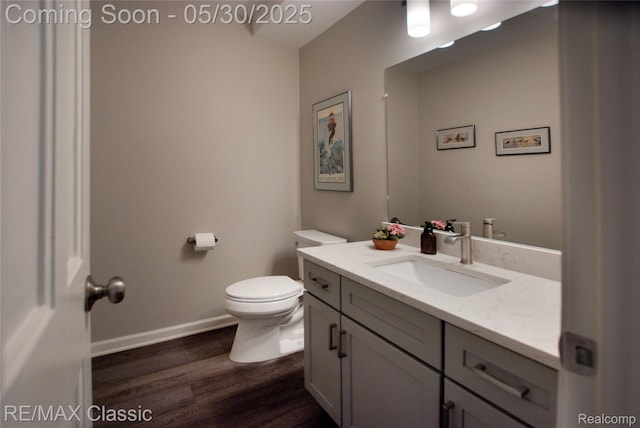 44500 Louvert Ct, Novi, MI 48375 - bathroom with vanity, wood finished floors, toilet, and baseboards
