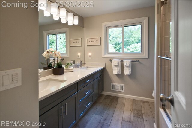44500 Louvert Ct, Novi, MI 48375 - full bathroom with double vanity, toilet, hardwood / wood-style flooring, and baseboards