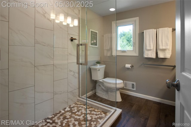 44500 Louvert Ct, Novi, MI 48375 - bathroom with toilet, a shower stall, wood finished floors, and baseboards