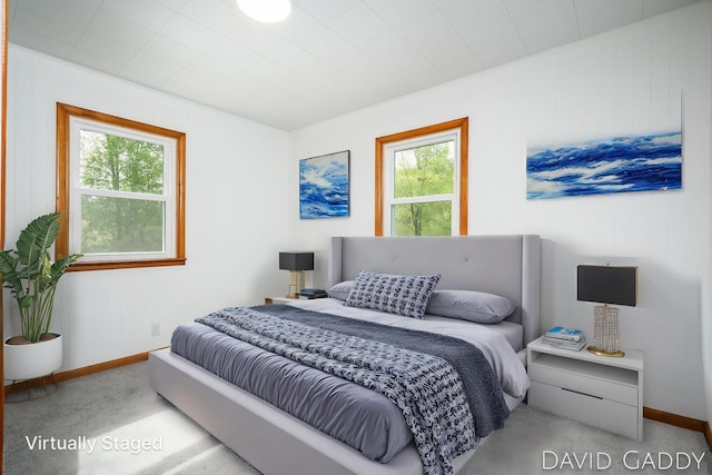 9081 E Baker Rd, Hesperia, MI 49421 - bedroom with multiple windows, carpet, baseboards, and wood walls