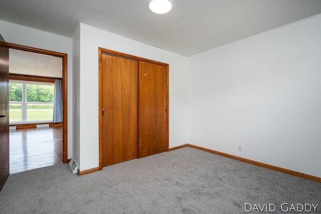 9081 E Baker Rd, Hesperia, MI 49421 - unfurnished bedroom featuring carpet floors, baseboards, and a closet