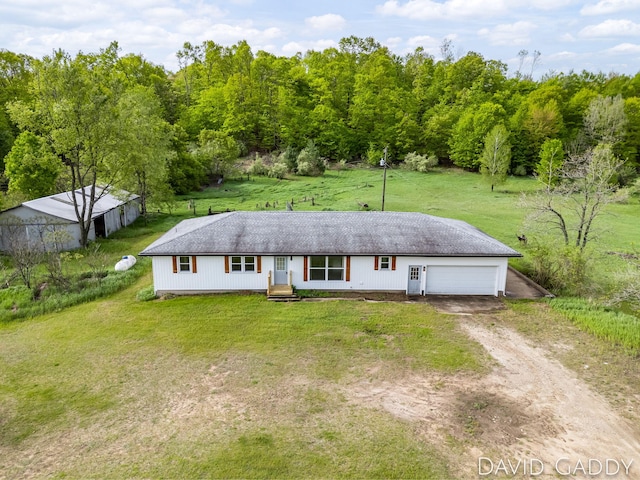 9081 E Baker Rd, Hesperia, MI 49421 - view of front of house featuring driveway, a front lawn, and an attached garage