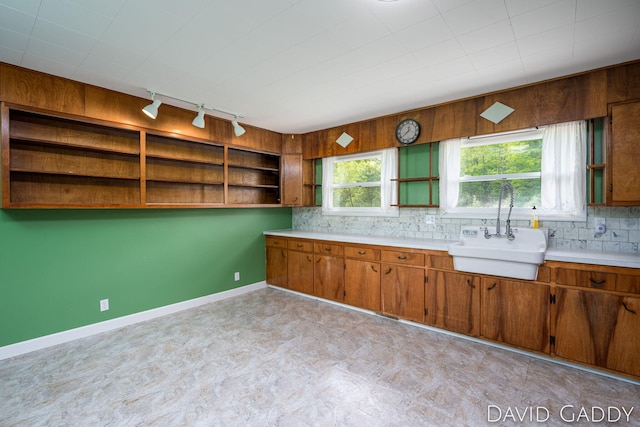 9081 E Baker Rd, Hesperia, MI 49421 - kitchen featuring open shelves, rail lighting, a sink, brown cabinets, and light countertops
