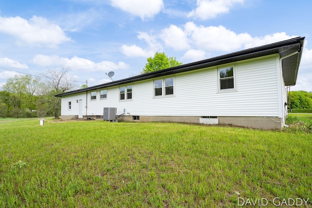 9081 E Baker Rd, Hesperia, MI 49421 - rear view of house featuring central AC unit and a lawn