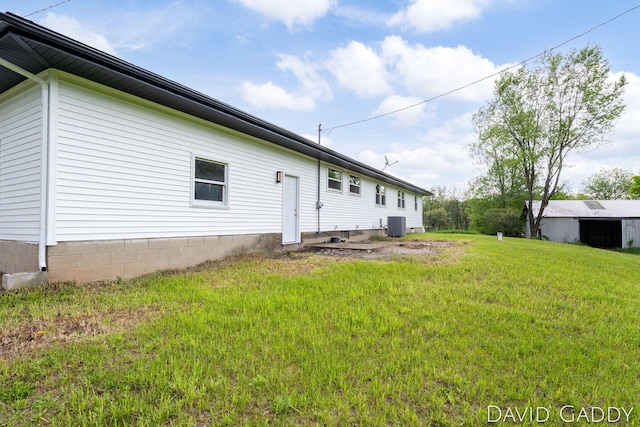 9081 E Baker Rd, Hesperia, MI 49421 - rear view of property with a lawn and central AC