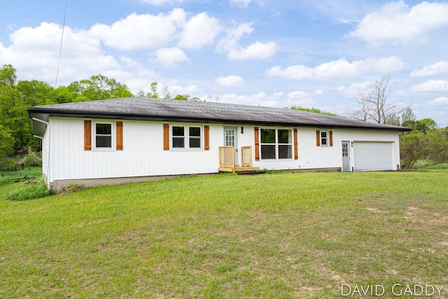 9081 E Baker Rd, Hesperia, MI 49421 - back of house with a garage and a yard