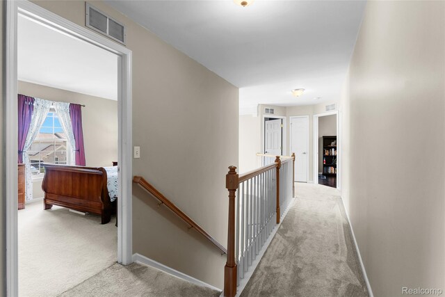 6241 Sapphire Ct, Grand Blanc, MI 48439 - hallway featuring an upstairs landing, carpet flooring, and baseboards