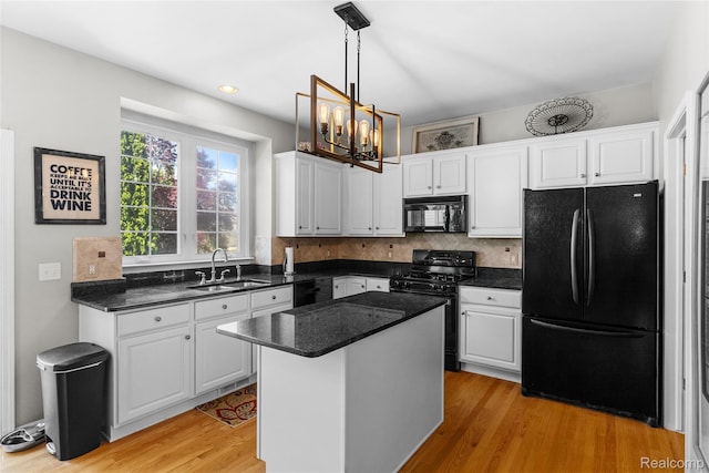 6241 Sapphire Ct, Grand Blanc, MI 48439 - kitchen with black appliances, a sink, white cabinetry, a chandelier, and light wood finished floors