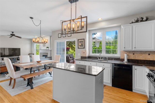 6241 Sapphire Ct, Grand Blanc, MI 48439 - kitchen featuring dishwasher, a sink, a chandelier, light wood-style floors, and recessed lighting