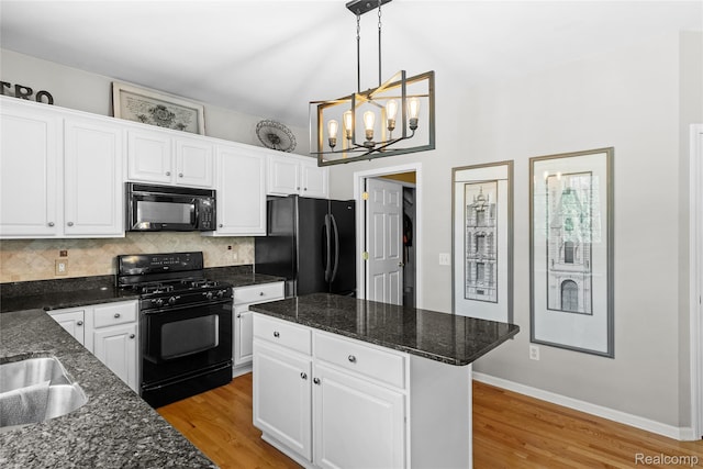 6241 Sapphire Ct, Grand Blanc, MI 48439 - kitchen featuring black appliances, a chandelier, backsplash, and light wood-style floors