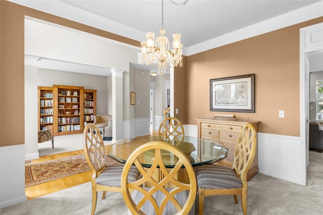 6241 Sapphire Ct, Grand Blanc, MI 48439 - dining area featuring a chandelier, a wainscoted wall, decorative columns, and crown molding