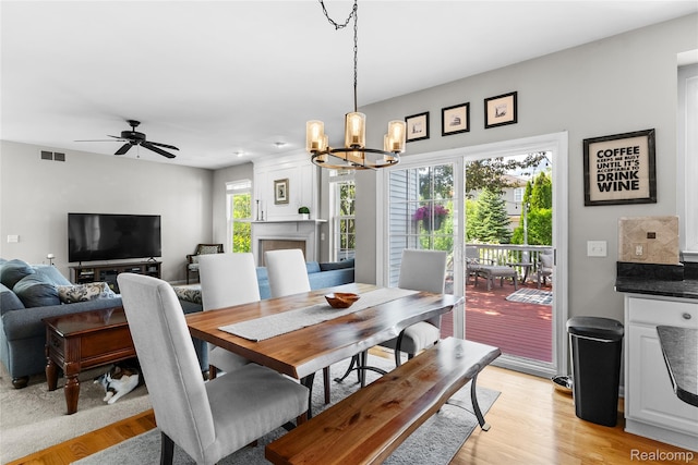 6241 Sapphire Ct, Grand Blanc, MI 48439 - dining area featuring a chandelier, light wood finished floors, and a ceiling fan