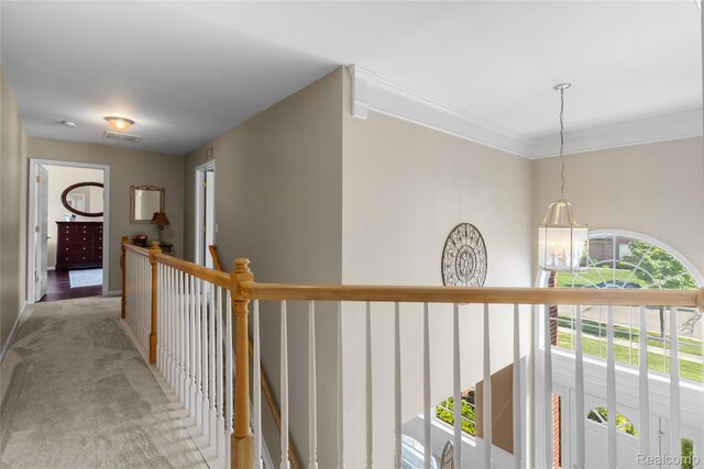 6241 Sapphire Ct, Grand Blanc, MI 48439 - hall with a chandelier, an upstairs landing, light colored carpet, and ornamental molding