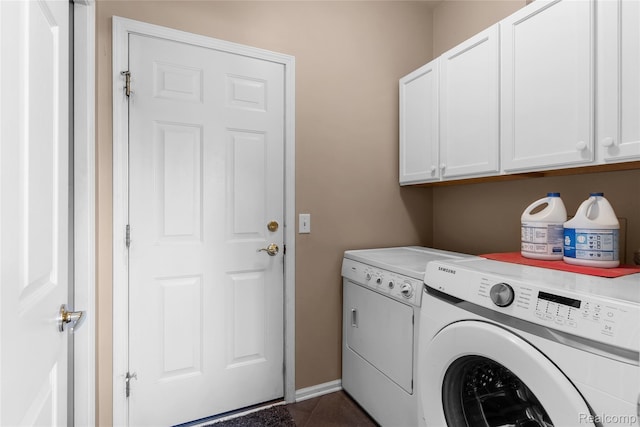 6241 Sapphire Ct, Grand Blanc, MI 48439 - laundry area with cabinet space, separate washer and dryer, dark tile patterned floors, and baseboards