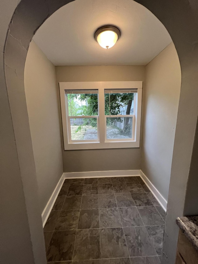 1008 S Holmes St, Lansing, MI 48912 - unfurnished room featuring arched walkways and baseboards