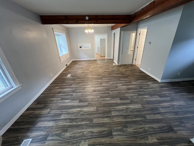 937 S Holmes St, Lansing, MI 48912 - empty room with beamed ceiling, baseboards, a chandelier, and dark wood finished floors