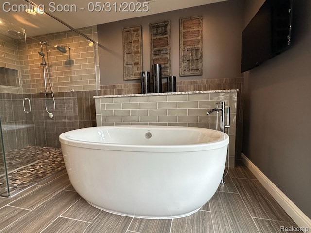 52006 Finch Ct, Shelby Twp, MI 48315 - bathroom with tile walls, a freestanding tub, a shower stall, and tile patterned floors