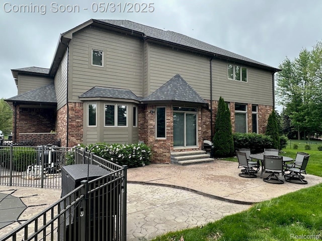 52006 Finch Ct, Shelby Twp, MI 48315 - back of property featuring brick siding, entry steps, and a patio