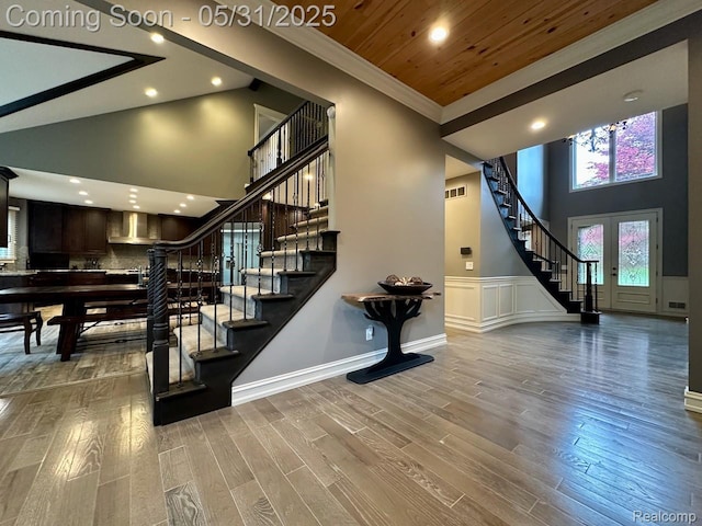 52006 Finch Ct, Shelby Twp, MI 48315 - stairs with a towering ceiling, ornamental molding, wood finished floors, recessed lighting, and wainscoting