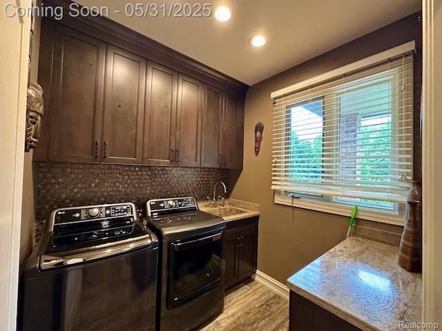 52006 Finch Ct, Shelby Twp, MI 48315 - laundry room featuring separate washer and dryer, cabinet space, light wood-style flooring, baseboards, and recessed lighting