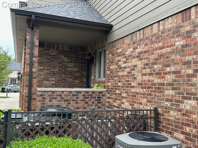 52006 Finch Ct, Shelby Twp, MI 48315 - view of side of home with brick siding, central air condition unit, and roof with shingles