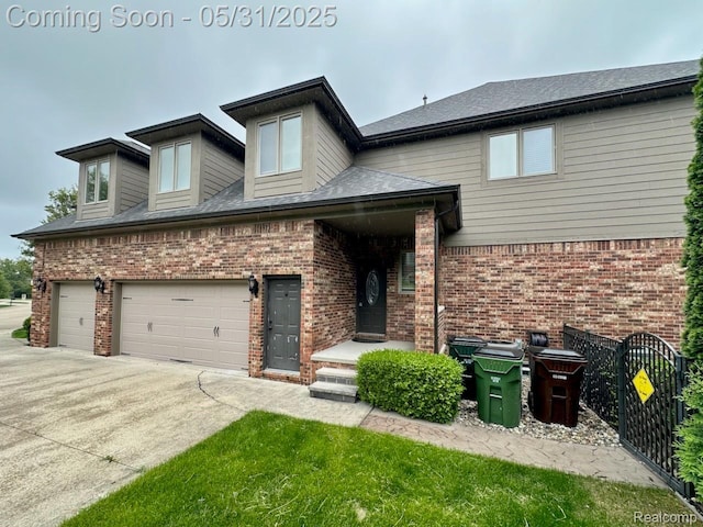 52006 Finch Ct, Shelby Twp, MI 48315 - view of front facade featuring brick siding, concrete driveway, and an attached garage