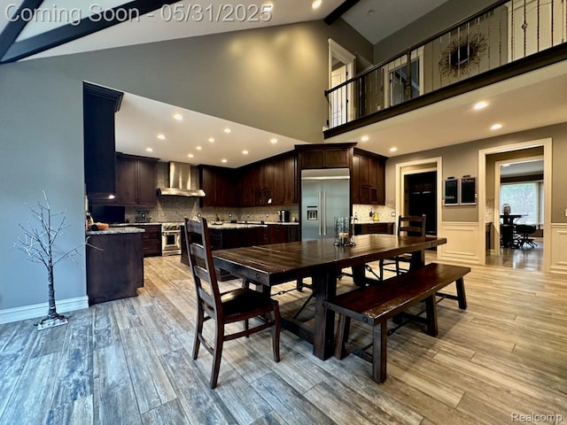 52006 Finch Ct, Shelby Twp, MI 48315 - dining area with light wood-style floors, high vaulted ceiling, beam ceiling, recessed lighting, and wainscoting
