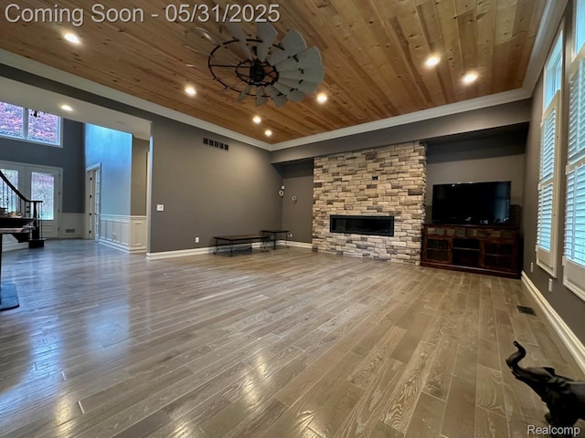 52006 Finch Ct, Shelby Twp, MI 48315 - unfurnished living room with wooden ceiling, ornamental molding, a fireplace, wood finished floors, and stairway