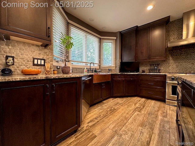 52006 Finch Ct, Shelby Twp, MI 48315 - kitchen featuring wall chimney range hood, appliances with stainless steel finishes, light wood-style floors, backsplash, and dark brown cabinets