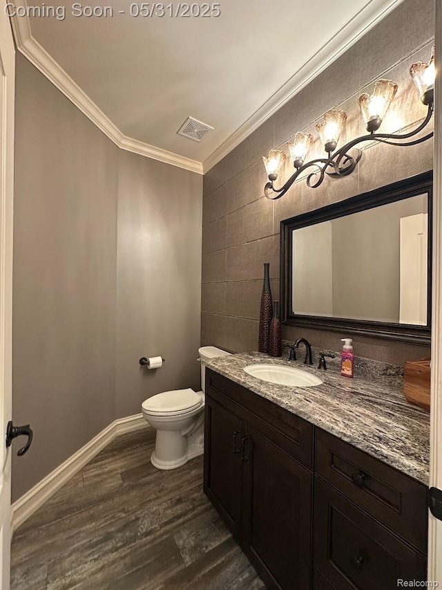 52006 Finch Ct, Shelby Twp, MI 48315 - bathroom featuring crown molding, vanity, wood finished floors, toilet, and tile walls