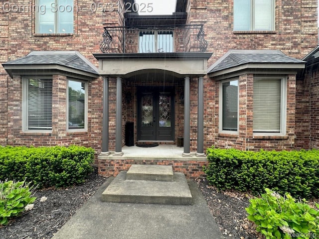 52006 Finch Ct, Shelby Twp, MI 48315 - property entrance with a balcony, brick siding, and french doors