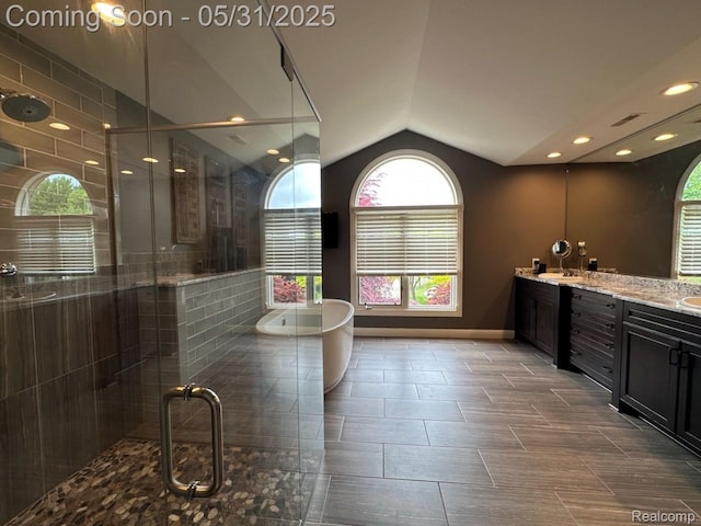 52006 Finch Ct, Shelby Twp, MI 48315 - bathroom featuring vaulted ceiling, double vanity, a freestanding bath, a shower stall, and plenty of natural light