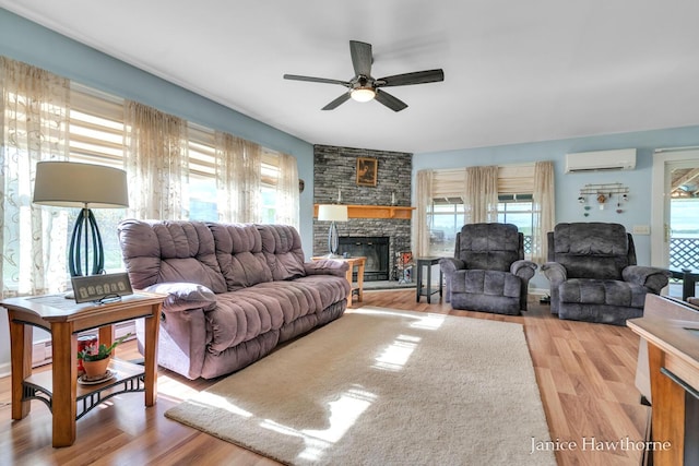 5777 N Broadway, Freeport, MI 49325 - living room with a wall mounted air conditioner, healthy amount of natural light, ceiling fan, and light wood-style flooring