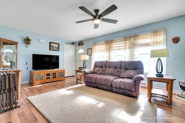 5777 N Broadway, Freeport, MI 49325 - living room with ceiling fan, light wood finished floors, baseboards, and baseboard heating