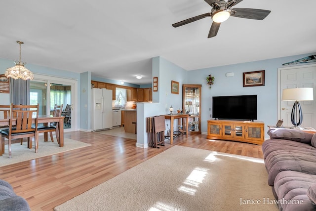 5777 N Broadway, Freeport, MI 49325 - living room with light wood-type flooring, a ceiling fan, and baseboards