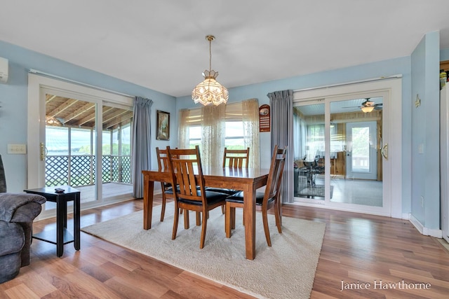 5777 N Broadway, Freeport, MI 49325 - dining room featuring plenty of natural light, a chandelier, and wood finished floors