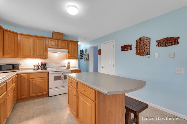 5777 N Broadway, Freeport, MI 49325 - kitchen featuring white range with electric stovetop, under cabinet range hood, stainless steel microwave, a kitchen island, and a kitchen breakfast bar