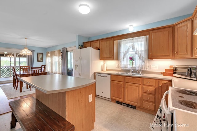 5777 N Broadway, Freeport, MI 49325 - kitchen featuring white appliances, a sink, light countertops, a center island, and light flooring